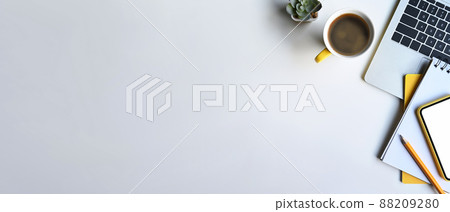 Top view laptop computer, coffee cup, notebook and succulent plant on white table with copy space. 88209280