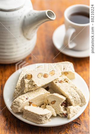 Sweet tahini halva with almonds. Turkish dessert on plate. Sweet tahini halva with almonds. Turkish dessert on plate. 88210224