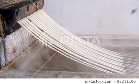 Recycled molten plastic comes out of the extruder machine Concept of recycling, plastic, industry, factories. Continuous extrusion with cooling in water to be processed into a pellet. 88211100