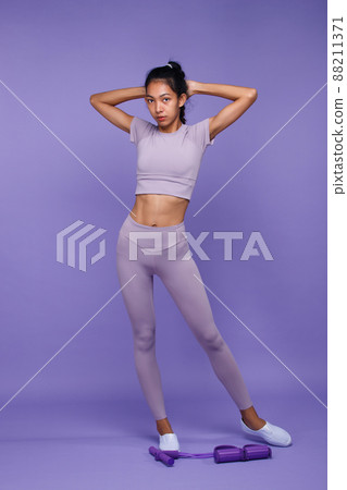 Full length of Asian slim tanned skin Fitness woman stand and show six packs strong muscle belly Full length of Asian slim tanned skin Fitness woman stand and show six packs strong muscle belly 88211371