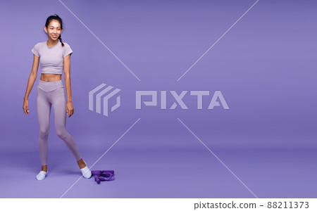 Full length of Asian slim tanned skin Fitness woman stand and show six packs strong muscle belly Full length of Asian slim tanned skin Fitness woman stand and show six packs strong muscle belly 88211373