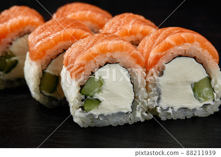 Sushi roll with smoked tuna with cucumber and - Stock Photo