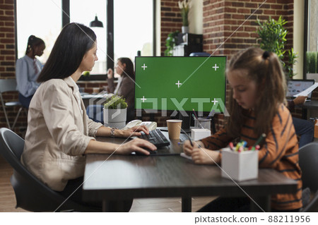 Working businesswoman using greenscreen on computer in agency office. Startup employee looking at monitor with blank mockup background, isolated template and chroma key copy space on display. Working businesswoman using greenscreen on computer in agency office. Startup employee looking at monitor with blank mockup background, isolated template and chroma key copy space on display. 88211956