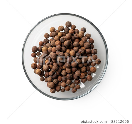 Allspice jamaica pepper in a glass saucer cutout.  88212696