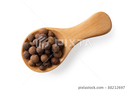 Wooden spice shovel full of allspice pimento berries cutout. 88212697