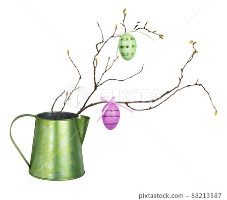 Spring twig with small buds of leaves and Easter eggs in a green metal jag isolated 88213587