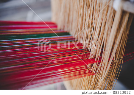 Thai and Asian Style Vintage textile thread machine to make traditional clothing and fabric pattern weaving. 88213932