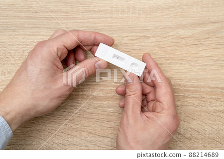Hand showing negative Covid-19 rapid antigen test 88214689