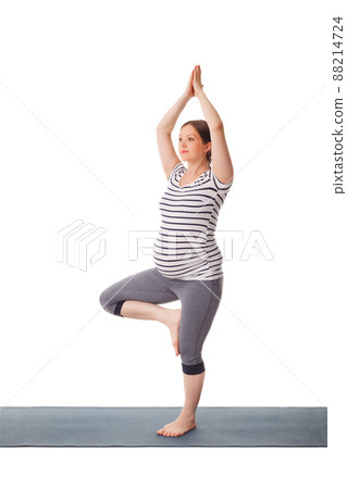Pregnant woman doing yoga asana Vrikshasana Pregnant woman doing yoga asana Vrikshasana 88214724