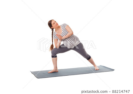 Pregnant woman doing yoga asana Utthita Parsvakonasana Pregnant woman doing yoga asana Utthita Parsvakonasana 88214747