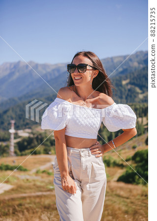 Beautiful happy young woman in mountains in the background of fog 88215735