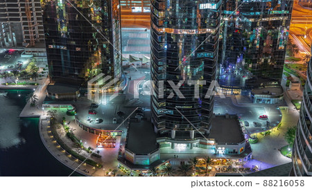 Tall residential buildings at JLT aerial night timelapse, part of the Dubai multi commodities centre mixed-use district. Tall residential buildings at JLT aerial night timelapse, part of the Dubai multi commodities centre mixed-use district. 88216058