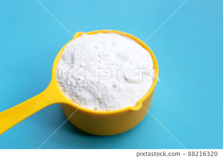 Baking soda on blue background. 88216320