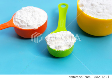 Baking soda on blue background. Baking soda on blue background. 88216321