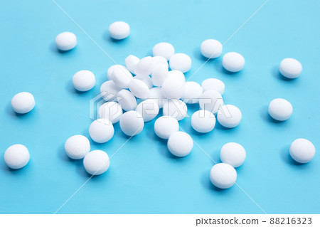 Naphthalene mothballs on blue backgrond. 88216323