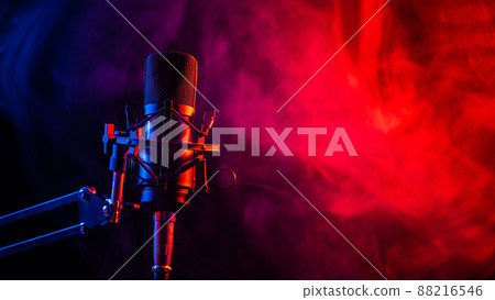 Professional microphone in pink smoke on a black background. Professional microphone in pink smoke on a black background. 88216546
