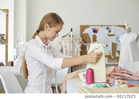 Woman seamstress work with fabric in fashion atelier Woman seamstress work with fabric in fashion atelier 88217025