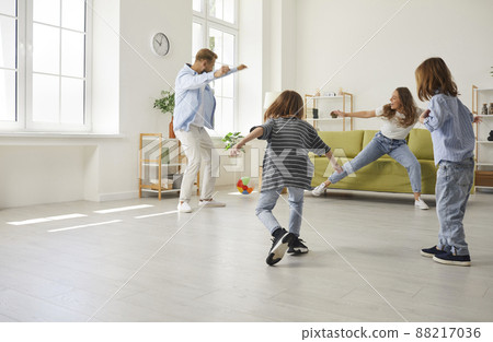 Happy family with kids play football at home Happy family with kids play football at home 88217036