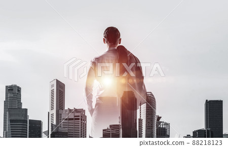 Concept of business success and control with confident boss against cityscape background 88218123