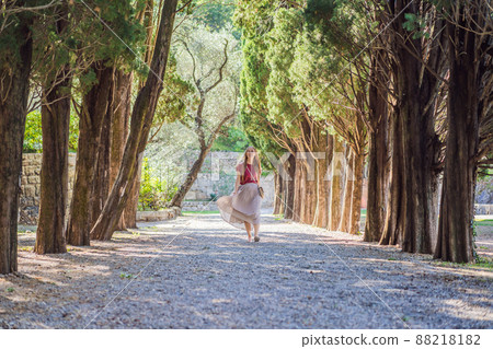 Woman tourist walking together in Montenegro. Panoramic summer landscape of the beautiful green Royal park Milocer on the shore of the the Adriatic Sea, Montenegro Woman tourist walking together in Montenegro. Panoramic summer landscape of the beautiful green Royal park Milocer on the shore of the the Adriatic Sea, Montenegro 88218182