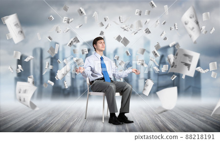 businessman meditates on office chair 88218191