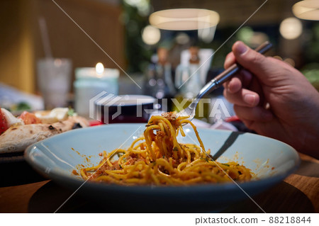 fresh hot spaghetti with cheese on fork with vapor, closeup, square format. 88218844