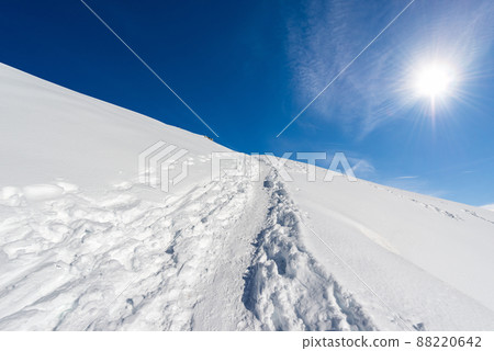 Winter Landscape with Snow against a Clear Blue Sky with Sunbeams 88220642