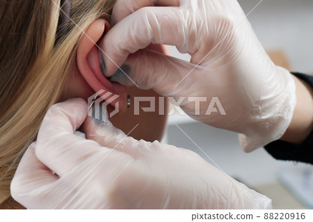 piercings on an ear. Conch and helix piercings close up. 88220916