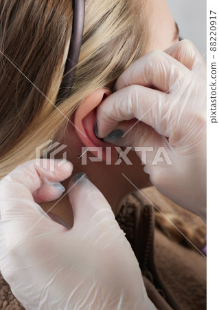 piercings on an ear. Conch and helix piercings close up. 88220917