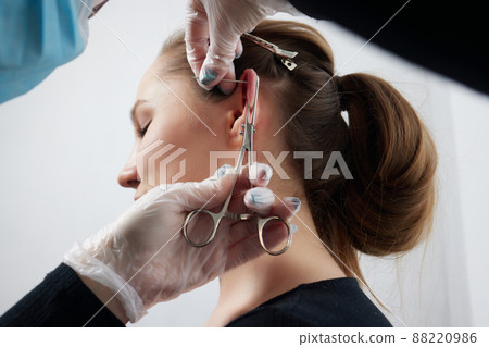 piercings on an ear. Conch and helix piercings close up. piercings on an ear. Conch and helix piercings close up. 88220986