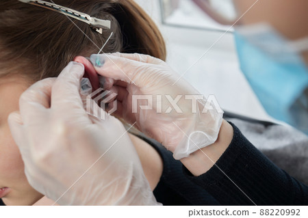 piercings on an ear. Conch and helix piercings close up. 88220992