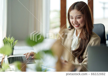 Portrait of charming young businesswoman working with laptop computer for financial on laptop in boardroom Portrait of charming young businesswoman working with laptop computer for financial on laptop in boardroom 88222882