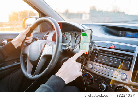 Gps navigation map system. Global positioning system on smartphone screen in auto car on travel road. GPS device satellite system technology. Gps navigation map system. Global positioning system on smartphone screen in auto car on travel road. GPS device satellite system technology. 88224057