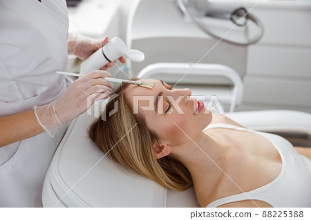 Young woman receiving skincare treatment in beauty salon Young woman receiving skincare treatment in beauty salon 88225388