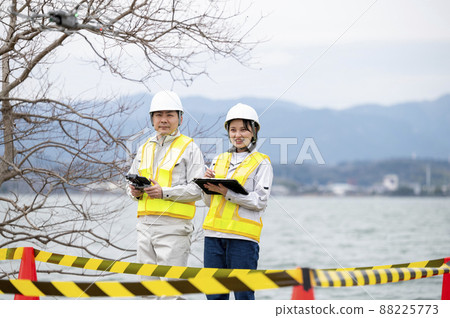 Worker operating a drone, taken in March 2022 in Shiga Prefecture 88225773