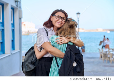 Mom hugging daughter outdoors, happy mother's face close up 88226115