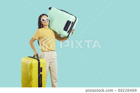 Smiling woman with suitcases ready for summer vacation Smiling woman with suitcases ready for summer vacation 88226489