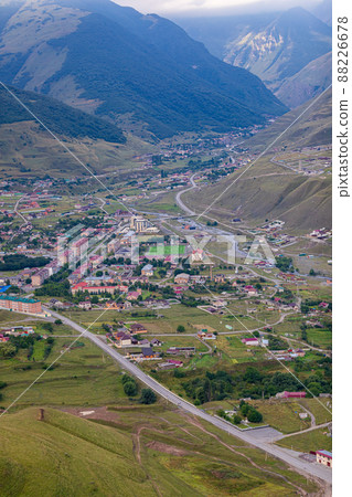 Mountain landscape with a city at the bottom of the gorge. Upper Fiagdon in North Ossetia Mountain landscape with a city at the bottom of the gorge. Upper Fiagdon in North Ossetia 88226678