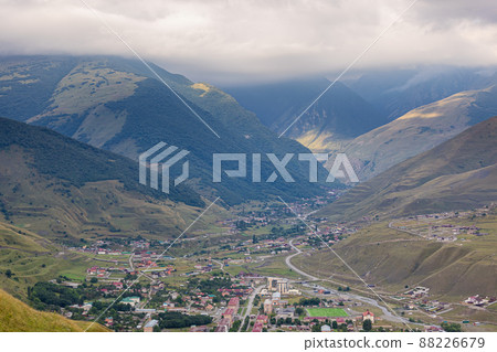Mountain landscape with a city at the bottom of the gorge. Upper Fiagdon in North Ossetia 88226679