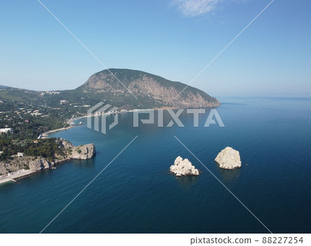 GURZUF, CRIMEA - Aerial Panoramic view on Gurzuf bay with Bear mountain Ayu-Dag and rocks Adalary, Artek - oldest children vacation camp. Yalta region, the South coast of Crimea peninsula GURZUF, CRIMEA - Aerial Panoramic view on Gurzuf bay with Bear mountain Ayu-Dag and rocks Adalary, Artek - oldest children vacation camp. Yalta region, the South coast of Crimea peninsula 88227254