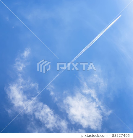 Blue sky, white clouds, airplane and trace, condensation trails, vapor trails 88227405