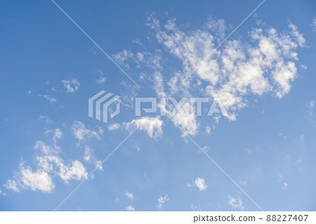 Blue sky with soft fluffy white clouds in summer day, background 88227407