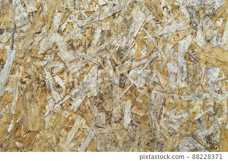 Texture of OSB panel board made of wood shavings, old pressed wood planks Texture of OSB panel board made of wood shavings, old pressed wood planks 88228371