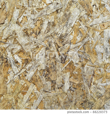 Texture of OSB panel board made of wood shavings, old pressed wood planks Texture of OSB panel board made of wood shavings, old pressed wood planks 88228373