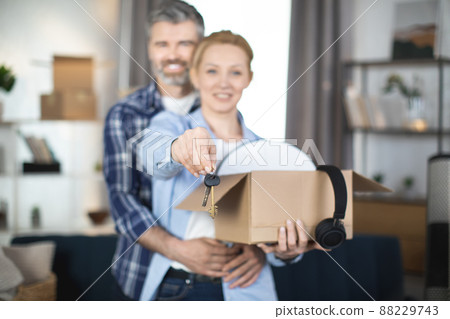 Caucasian couple holding boxes with keys at new flat Caucasian couple holding boxes with keys at new flat 88229743