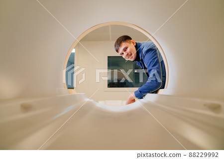 installer engineer of mri apparatus in scanner. blue uniform 88229992