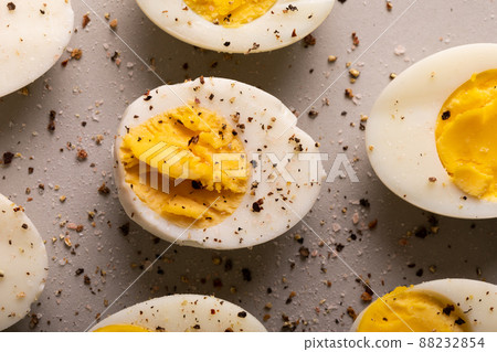Overhead close-up view of fresh boiled white eggs with peppercorn seasoning Overhead close-up view of fresh boiled white eggs with peppercorn seasoning 88232854