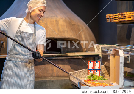 Chef preparing pizza in the bakery shop Chef preparing pizza in the bakery shop 88232999