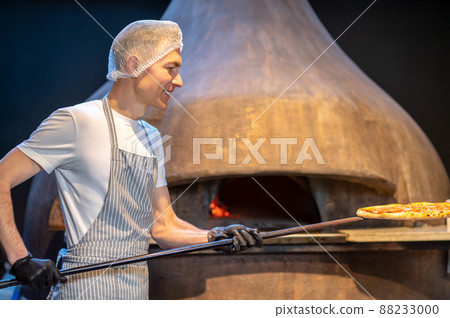 Chef preparing pizza in the bakery shop Chef preparing pizza in the bakery shop 88233000