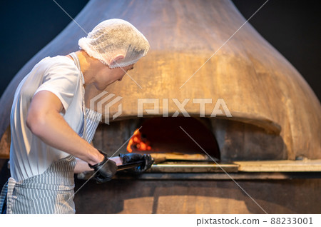 Chef preparing pizza in the bakery shop Chef preparing pizza in the bakery shop 88233001